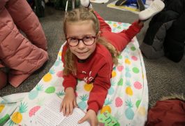 Student Reads on a towel