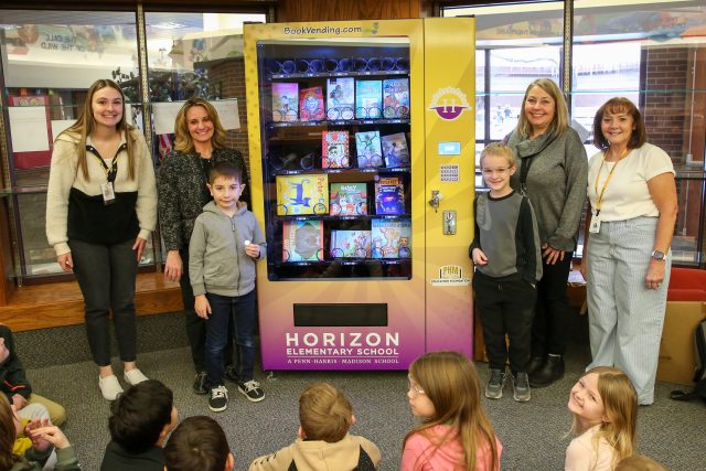 students with book vending machine