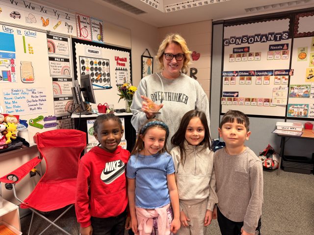 Mrs. Hapke with her award and students