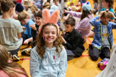 Children in colorful hats they made posing for a picture.